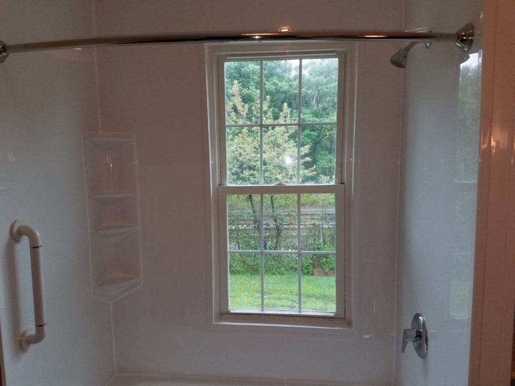 New York Sash can work around any space provided, even with a window in the middle of the bath area!