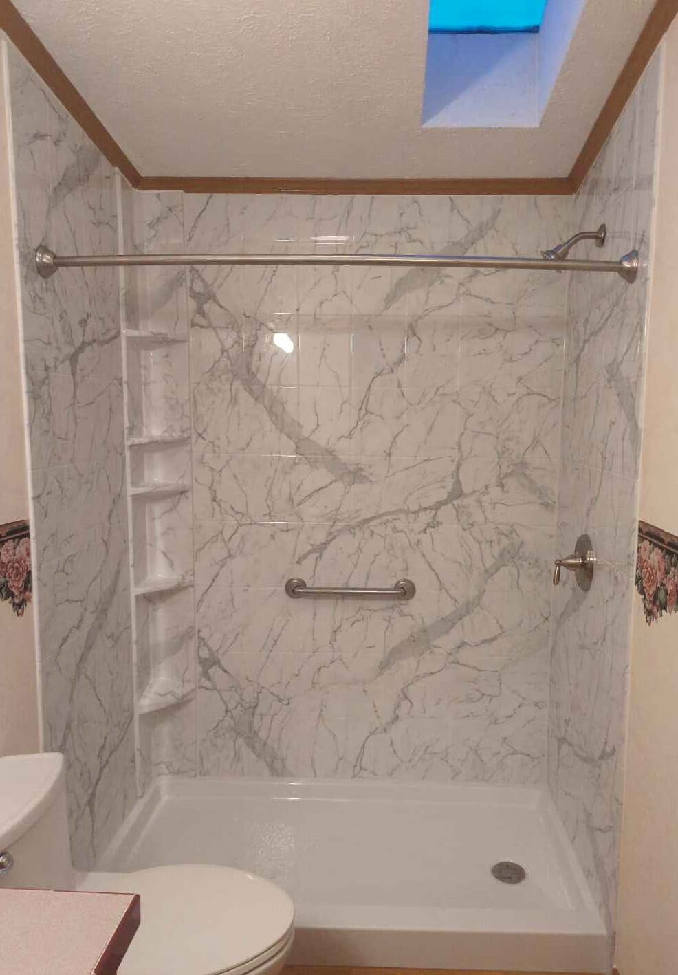 Walk-in shower with accessories and fixtures.